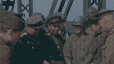 Men In Military Uniforms Standing In Circle GIF