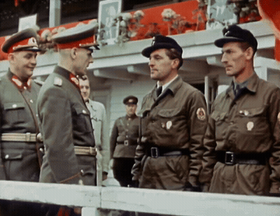 Men In Military Uniforms Standing In Front Of Railing GIF