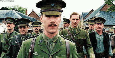 Men In Military Uniforms Walking Down Street The Hummingbird GIF