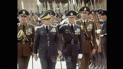 Men In Military Uniforms Walking In Line GIF