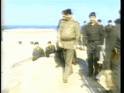 Men In Military Uniforms Walking On Beach GIF