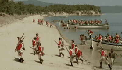 Men In Red And White Running On Beach GIF