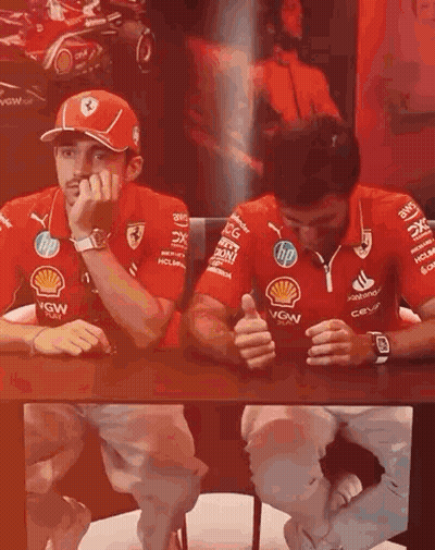 Men In Red Ferrari Shirts Sitting At Table GIF