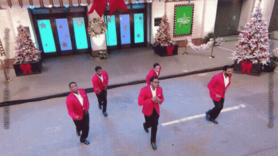 Men In Red Jackets Dancing In Front Of Abc Building GIF