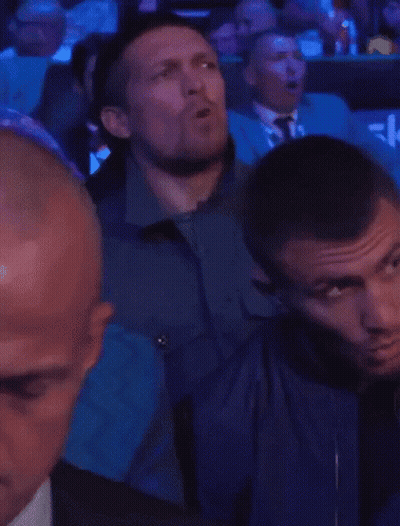 Men In Stadium With Blue Seat Saying Sky GIF