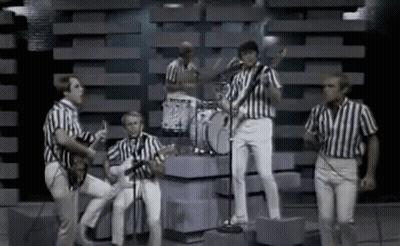 Men In Striped Shirts Playing Instruments On Stage GIF