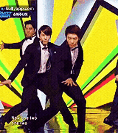 Men In Suits And Bow Ties Dancing On Stage GIF