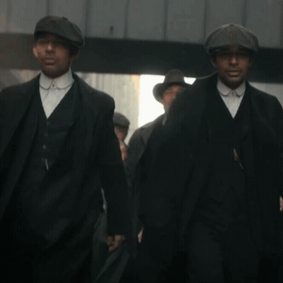 Men In Suits And Hats Walking Down Street GIF