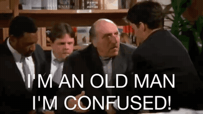 Men In Suits And Ties Talking At Table GIF