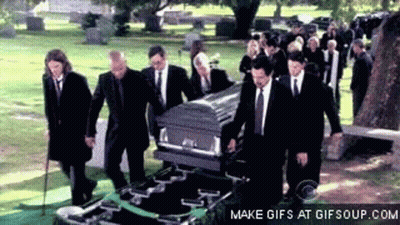 Men In Suits Carrying Coffin In Cemetery GIF