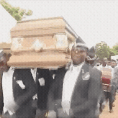 Men In Suits Carrying Coffin On Heads GIF