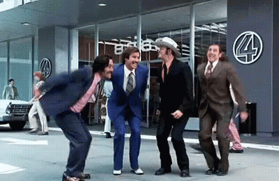 Men In Suits Dancing In Front Of Building GIF