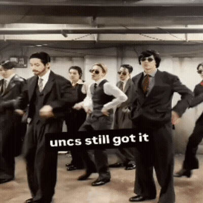 Men In Suits Dancing Under Uncs Still Got It Sign GIF