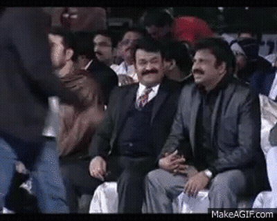 Men In Suits Laughing In Stadium GIF