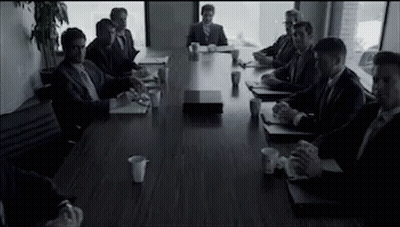 Men In Suits Sitting Around Conference Table GIF