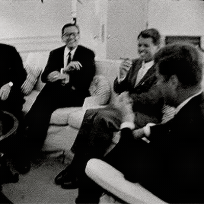 Men In Suits Smoking On Couch GIF