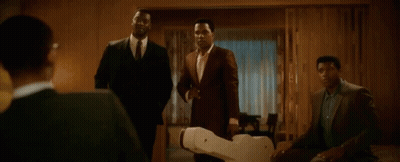 Men In Suits Standing Around Robot GIF