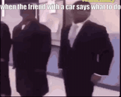 Men In Suits Standing In Hallway GIF