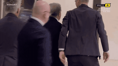 Men In Suits Walking Past Directe Z Sign GIF