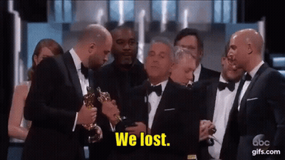 Men In Tuxedos Holding Oscar Trophy Saying We Lost GIF