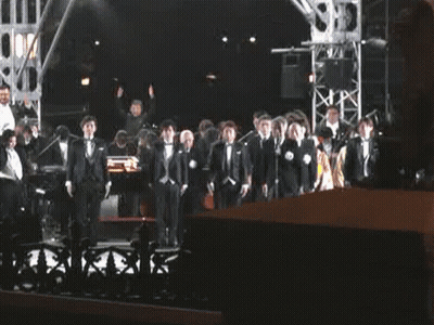 Men In Tuxedos On Stage GIF