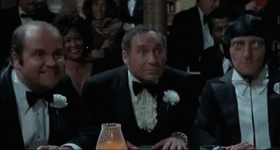 Men In Tuxedos Sitting At Casino Table GIF