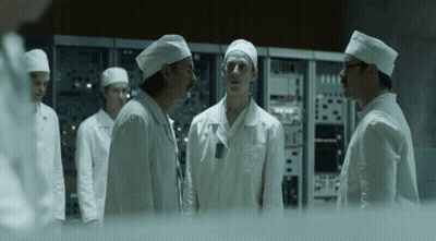 Men in White Coats and Hats Standing in Room