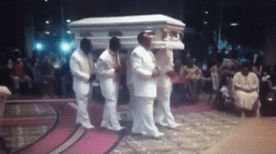 Men In White Suits Carrying Coffin GIF