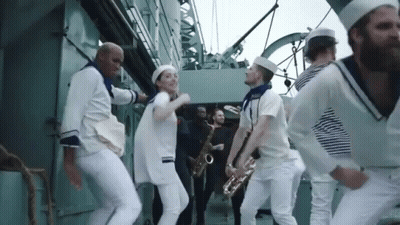 Men In White Suits Standing In Hallway GIF