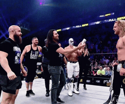 Men In Wrestling Ring With Join Dark Order Shirt GIF