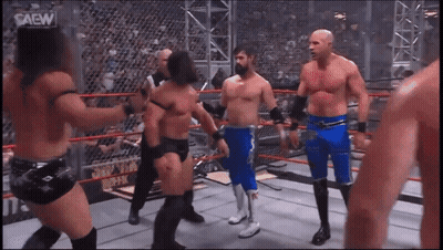 Men In Wrestling Ring With Saew GIF