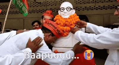 Men Kneeling In Front Of Statue With Glasses GIF