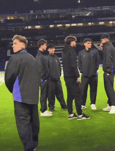 Men On Soccer Field With UEFA Champions League Sign GIF