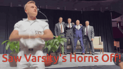 Men On Stage Saw Varsity's Horns Off In Red GIF