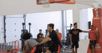 Men Playing Basketball One Wearing Bulls Shirt GIF