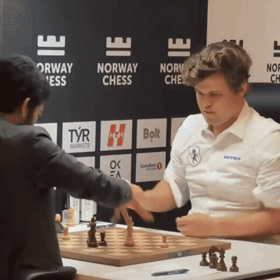 Men Playing Chess In Front Of Norway Chess Sign GIF