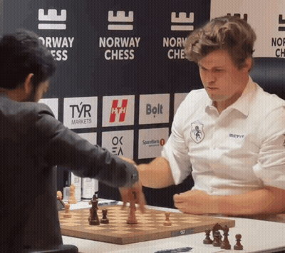 Men Playing Chess In Front Of Norway Sign GIF