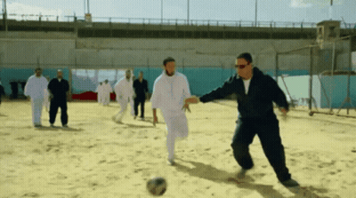 Men Playing Soccer In Sand GIF