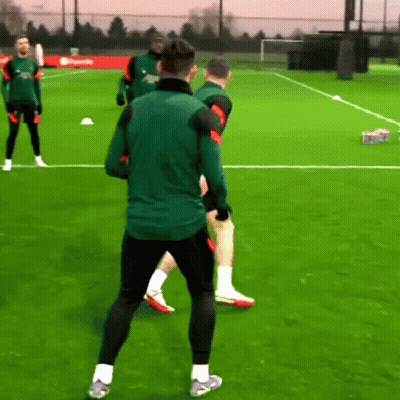 Men Playing Soccer, One In Green Nike Jacket GIF