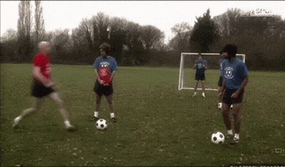 Men Playing Soccer With Goal GIF