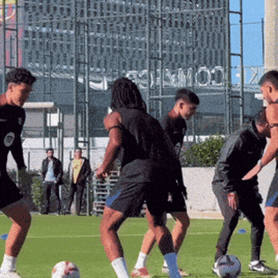 Men Playing Soccer With Stadium Sign GIF