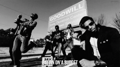 Men Posing In Front Of Goodwill Sign GIF
