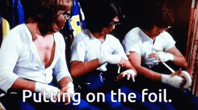 Men Putting On Foil In Dark Room GIF