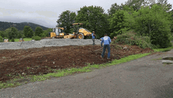 Men Raking Mulch On Roadside GIF