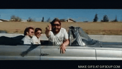Men Riding Silver Convertible Giving Middle Finger GIF
