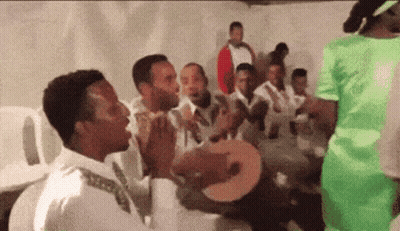 Men Singing And Playing Instruments With Man In Green Shirt GIF