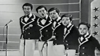 Men Singing Into Microphones On Star Wall GIF