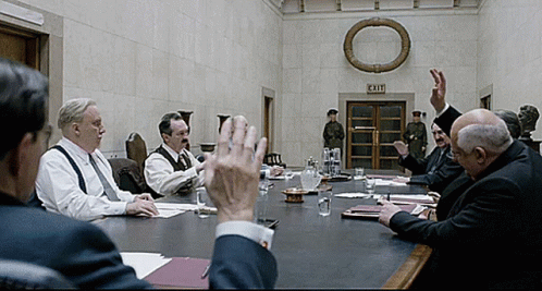 Men Sitting Around Table GIF