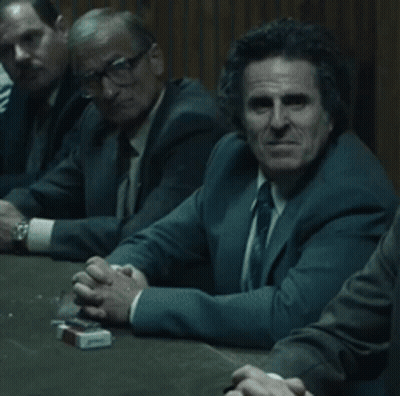 Men Sitting Around Table With Cigarettes GIF