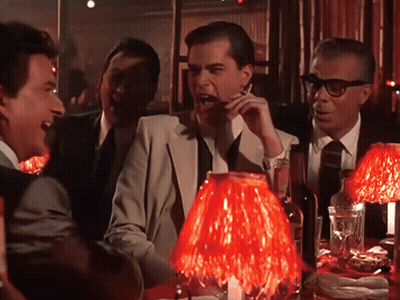 Men Sitting Around Table With Red Lamp GIF
